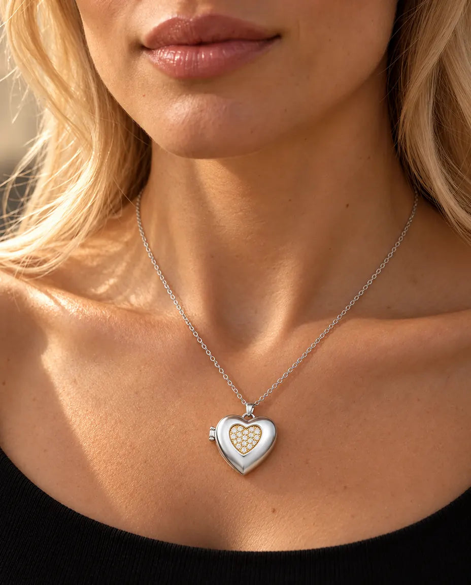 Woman in a black knit top wearing the silver tone two-tone pave heart photo locket necklace