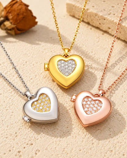 Three colors of the two-tone pave heart photo locket necklace arranged on plaster