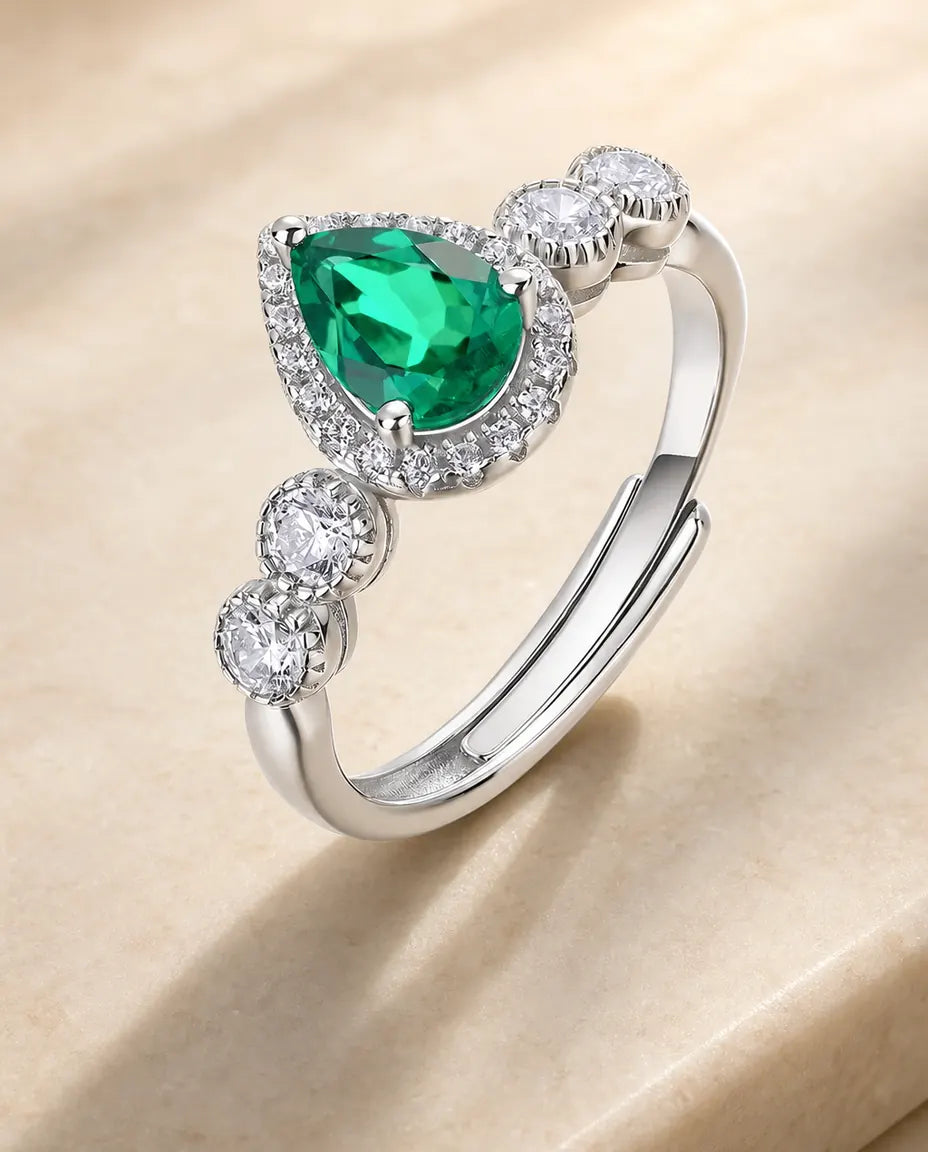 lab-created emerald pear-cut halo ring with graduated accents in sterling silver, adjustable