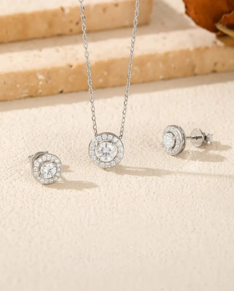 Round Moissanite Halo Jewelry Set in 925 Sterling Silver - the full set on a cream stone surface