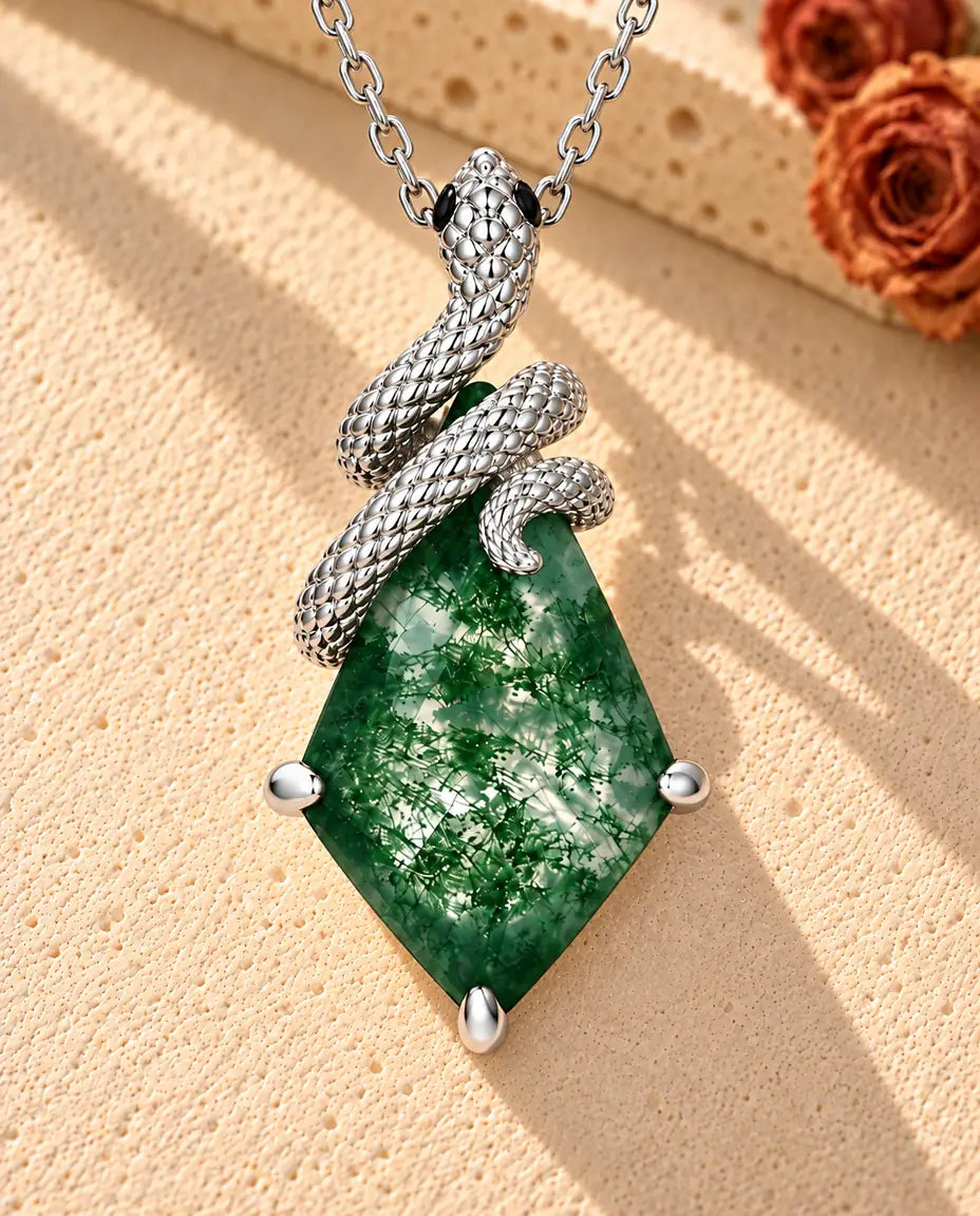 Snake Moss Agate Necklace in 925 Sterling Silver - lying on a cream textured surface beside a travertine block