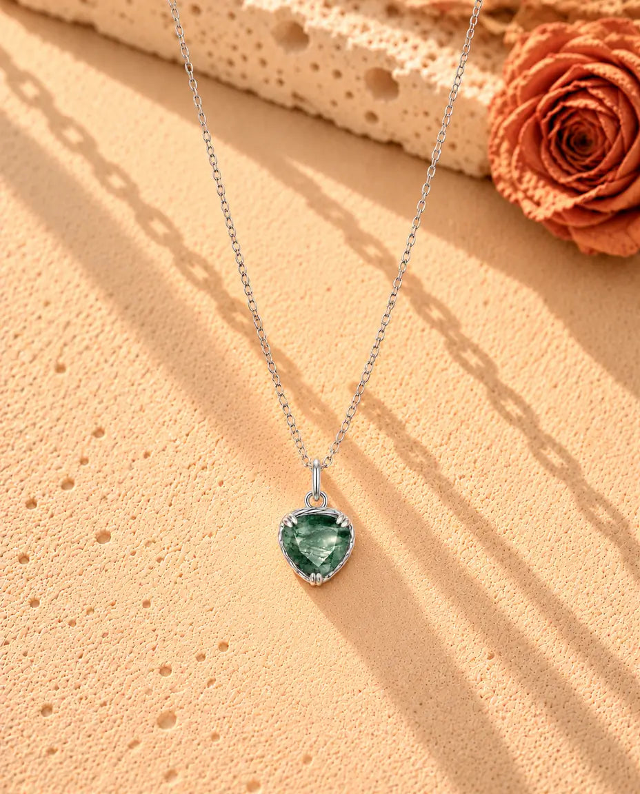 Heart Moss Agate Pendant Necklace in 925 Sterling Silver - the whole necklace laid out in a long V on a cream textured surface
