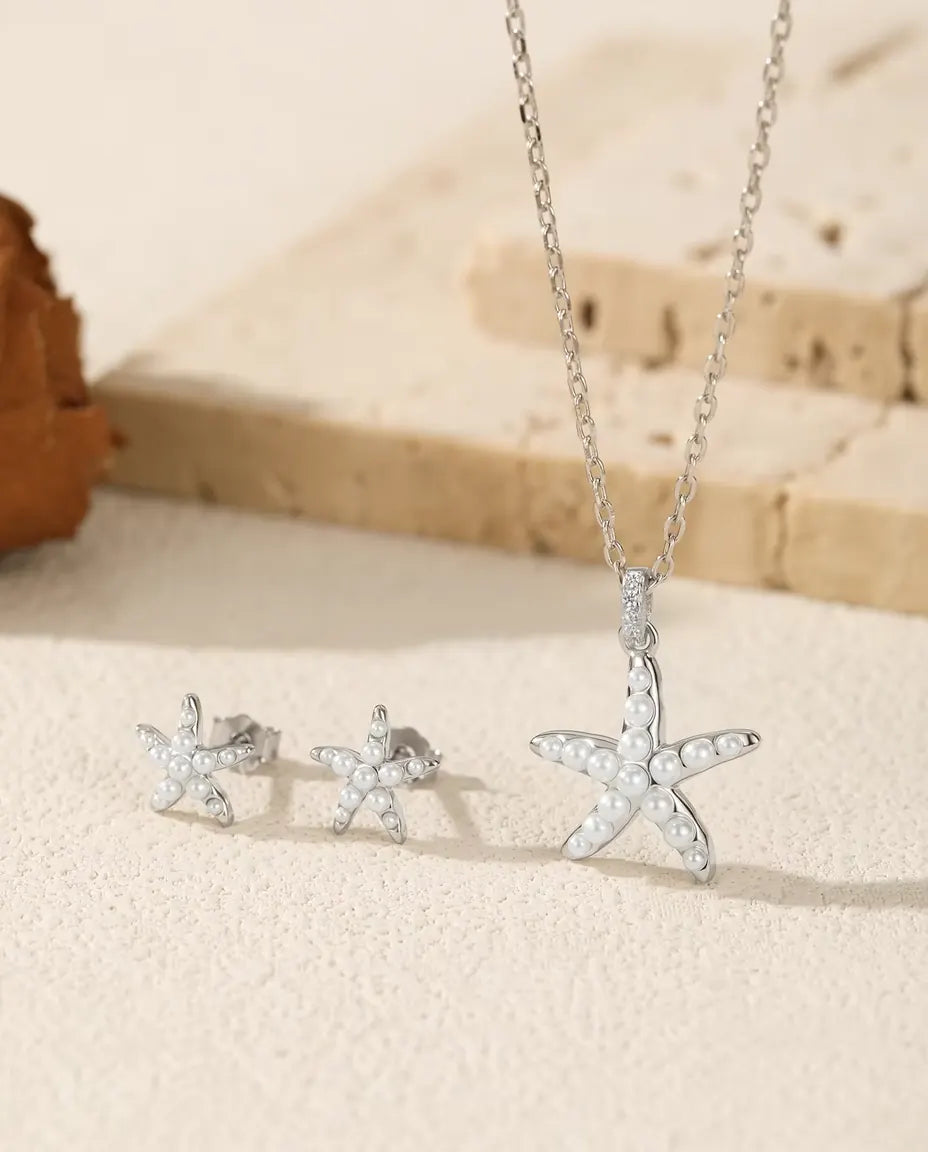 Starfish Jewelry Set in 925 Sterling Silver - the full set on a cream stone surface
