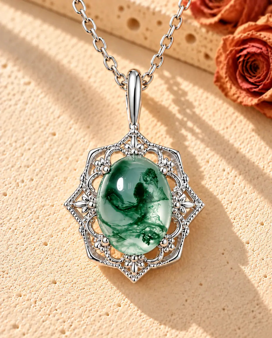 Vintage Moss Agate Pendant Necklace in 925 Sterling Silver - lying on a cream textured surface beside a travertine block