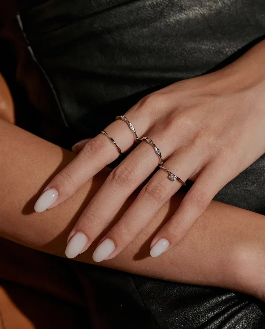 Wavy Band Ring in 925 Sterling Silver - worn together with other rings, hands resting on each other